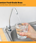 Hand holding glass under running water faucet near sink, premium food-grade brass, Three Eighths Inch Brass Compression Angle Stop Valve