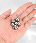 Hand holding 3MM stainless steel bearing balls from a 1000 Pack, showcasing durability for paint mixing and repairs.