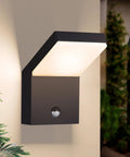 Fly Modern Outdoor Wall Light Featuring Smart Motion Sensor Delivered With Heavy Duty Led Illumination For Porch Patio Fence And Garage Security In Slick Black Aluminum Finish mounted on wall