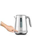Person using Smart Kettle Luxe 7-Cup Water Heater In Brushed Stainless Steel With Temperature Control For Perfect Tea Or Coffee Brew