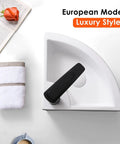 European modern luxury style corner sink with folded towel and book on a white surface.