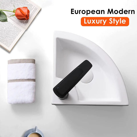 European modern luxury style corner sink with folded towel and book on a white surface.