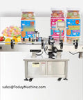 Smooth Operator Small Pneumatic Round Bottle Labeling Machine With Automatic Label Applicator For High Volume Industrial Packing Jobs And No Sweat Daily Workflow with jars of candy in background.