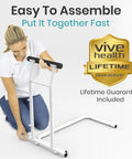 Woman assembling Heavy Duty Toilet Safety Rail With Arms providing top shelf bathroom support in white frame.