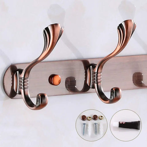 Heavy Duty Stainless Steel Wall Coat Rack With Five Sturdy Hooks For Coats Hats Robes And Towels close-up of bronze hooks on wall.