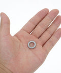 M10 Wedge Locking Washer held in hand, heavy duty manganese steel, anti vibration design for screws and bolts.