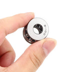 Model 51100 Plane Axial Thrust Ball Bearing With Double Seals held in hand, showing steel construction for heavy duty machinery.