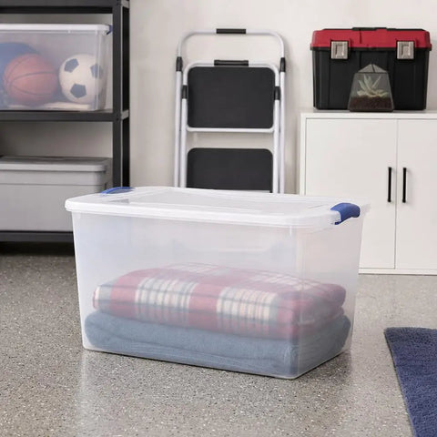 66 Quart Clear Plastic Storage Bin With Secure Blue Latch Lids Stackable Home Organization Tote For Garage Closet And Pantry, filled with stacked blankets.
