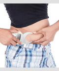 Person using Pinch And Read Digital Body Fat Caliper With LCD Display, Handheld Skinfold Fat Tester And Body Tape Measure on waist.