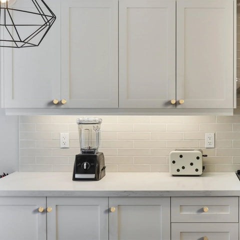 Modern kitchen view with 10 Pack Matte Black And Gold Knurled Cabinet Knobs For Kitchen Cabinets And Dressers Zinc Drawer Knobs installed on white cabinets