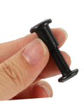 M6x25 Black Stainless Steel Binding Screws With Hex Socket barrel nut held in hand for furniture assembly or crafting use.