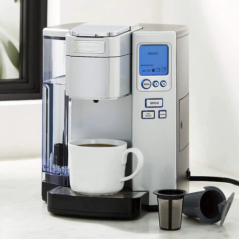 Two Pack Reusable Coffee Filter Cups For Single Serve Brewers Gray BPA Free Refillable Cup Filter next to coffee machine