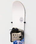 Minimalist Snowboard Wall Mount Display Rack Featuring Felt Padded Arms And Durable Rubber Grip To Stash Your Sick Ride Securely In Garage Or Home Studio And Recreation Room mounted with snowboard and bindings.