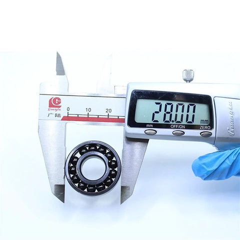 Kickass Heat Resistant Bearings 12X28X8Mm 500C Double Sealed Steel Balls measuring 28mm with digital caliper for precise sizing.