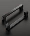 Two matte black cabinet handles from 30 Pack 5 Inch Square Matte Black Cabinet Handles For Cabinets Drawers And Dressers displayed on black surface.