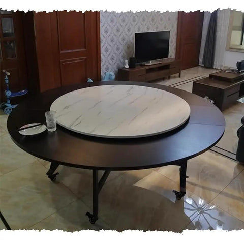 Super Slick Black Wooden Lazy Susan Turntable With Effortless Swivel Spin For Kitchen Countertops And Dining Tables on a large round table.