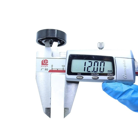 Digital caliper measuring 12mm diameter of Kickass Heat Resistant Bearings 12X28X8Mm 500C Double Sealed Steel Balls.