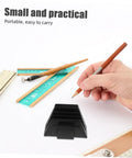12 Piece Modular Wrench Rack Organizer Tray for wrenches beside rulers, pencils, and hand writing on paper