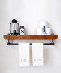 Industrial shelf with Three Quarters Inch Black Side Outlet Elbow Three Way Corner Pipe Fitting holding decor items and towels