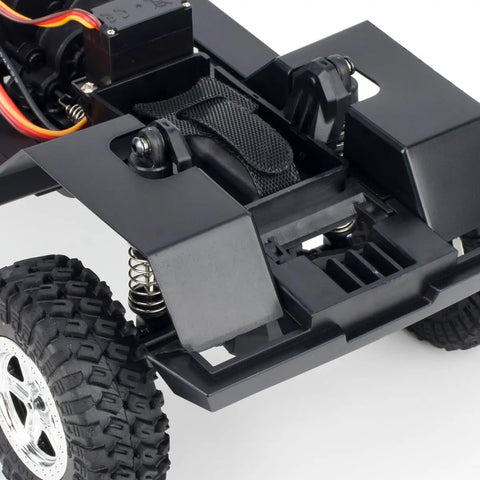 Close-up of Durable Steel Frame RC Crawler Chassis Assembled With 2 Speed Gearbox showing wheel and suspension details