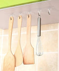 Heavy Duty Plastic Utility Hooks With Rock Solid Self Adhesive Backing For Damage Free Wall Mounting Reusable Bathroom Hangers Waterproof And Oil Proof 50 Pack holding wooden spatulas and whisk in kitchen.