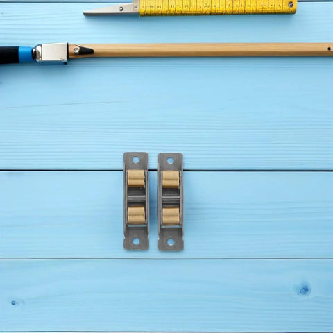 Heavy Duty Sliding Glass Door Rollers 2 Piece Set Featuring Double Wheel Bearings For Smooth As Silk Operations And Universal Track Compatibility For Quick No Sweat Upgrades Anywhere on blue wood background.