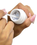 Hand holding Big League Free Chlorine Test Strips bottle, retrieving strip for water quality check, pack of fifty.