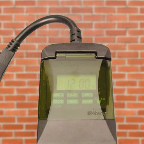 Weatherproof Seven Day Outdoor Digital Plug In Timer Featuring Dual Grounded Outlets And No Sweat Programming For Real Doggone Good Energy Savings That Keep Your Yard Looking Sharp All Week Long, showing timer display and controls.