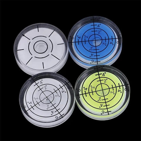 Round Bubble Level for Precision Measuring and Alignment Tasks, set of four levels in various colors, highlighting precision markings.
