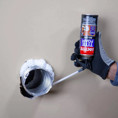 Person applying Big Gaps Spray Foam Sealant That Expands To Fill And Insulate Up To Three Inches, 12 Fl Oz Can to a wall gap.