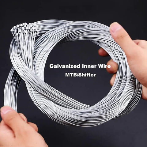 Two hands holding inner wires from the 10 Piece Bike Brake Cable And Shifter Cable Set For Mountain And Road Bikes
