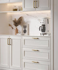 Top Shelf Champagne Bronze Cabinet Pulls 5 Inch 10 Pack Brushed Gold Drawer Handles on kitchen cabinetry with white finish.
