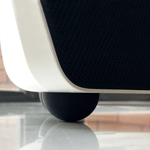 Close-up of 1.25 Inch Speaker Isolation Pads With Adhesive Rubber Feet Four Pack under subwoofer, showing vibration damping features.