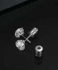 Fresh Hypoallergenic Titanium Stud Earrings With Secure Screwback Cap For Sensitive Ears Silver Tone Cubic Zirconia Stone resting on black surface.
