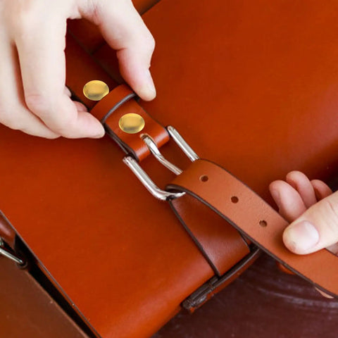 Hands securing Two Piece Titanium Alloy Binding Screws For Heavy Duty Document Sorting And Hella Durable Scrapbook Fasteners No Drama Snap Lock Photo Album Posts Prime Picks on a leather bag strap.
