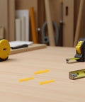 200 Pack Yellow Plastic Wall Anchors Kit Self Drilling Ribbed Anchors on a wood table with tools in the background