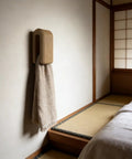 Premium Wall Mount Automatic Locking Towel Hook With Smart Space Saving Design And No Sweat Storage For Daily Grind In Slick Matte Black Finish For Any Modern Setup, featuring a cozy linen towel.