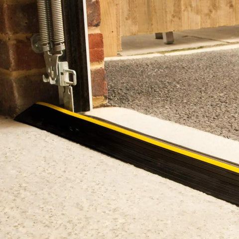 Beefed Up Garage Door Threshold Seal Kit With Adhesive And Bottom Weather Stripping For 10 Ft 6 In Wide Doors, close-up installation