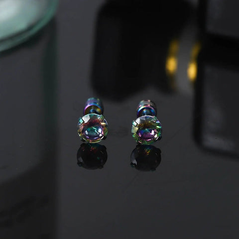 Premium 5A Cubic Zirconia Screw Back Stud Earrings For Men And Women on a reflective surface, showcasing their dazzling colors.