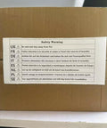 Safety warning label on cardboard box with multilingual instructions to stay away from fire.