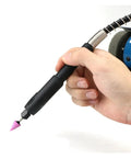 Hand holding a precision tool with a pink grinding tip for A Straight Up Rock Solid Mini Bench Grinder With A Beefy 150W Engine And Adjustable Speed.