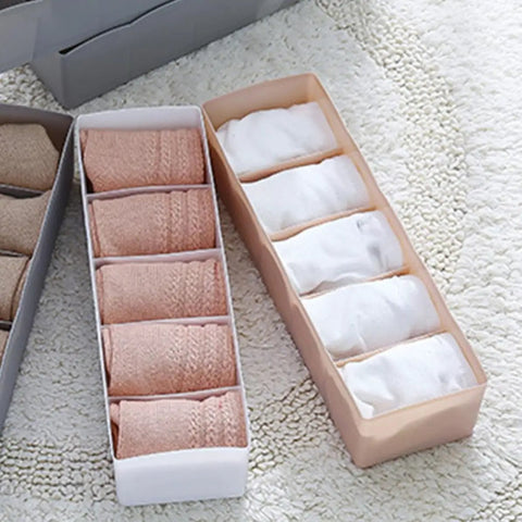 Six Piece Pink Plastic Underwear Drawer Organizer Set Smooth Dresser Storage Dividers with rolled socks in bins.