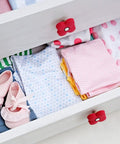 Top Shelf Cartoon Style Soft Grip Rubber Cabinet Knobs And Drawer Pulls For Kids Rooms Featuring Bulletproof Zinc Base Kid Approved Safe Finish And Zero Hassle Bolt Up Setup on a white dresser with colorful clothes and shoes.