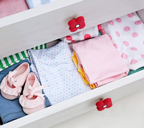 Top Shelf Cartoon Style Soft Grip Rubber Cabinet Knobs And Drawer Pulls For Kids Rooms Featuring Bulletproof Zinc Base Kid Approved Safe Finish And Zero Hassle Bolt Up Setup on a white dresser with colorful clothes and shoes.