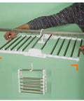 Heavy Duty Foldable Multi Layer Pants Hangers Crafted From Durable Stainless Steel shown being installed on a closet rod.