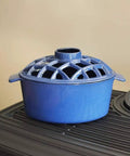 Heckin Cozy 2.2 Quart Enamel Woodstove Steamer With Decorative Lattice Top Cast Iron Humidifier on stove top.