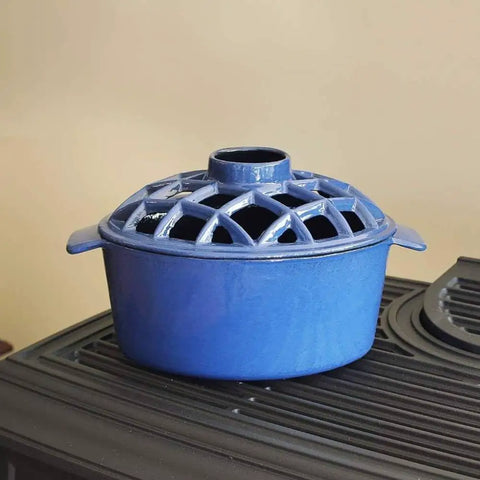 Heckin Cozy 2.2 Quart Enamel Woodstove Steamer With Decorative Lattice Top Cast Iron Humidifier on stove top.