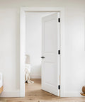 Pro Heavy Duty Self Closing Door Hinges 4 Inch 2 Pack on a white interior door with a black handle.