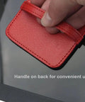Close-up of hand holding red PU leather handle of 4 Pack Elastic Strap Screen Cleaning Pads With Soft Cloth Wipes For All Screens