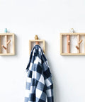 Built Tough Solid Wood Wall Mounted Coat Rack With Durable Hooks Versatile Entryway Organizer For Coats Hats Robes Towels And Backpacks showing plaid towel hanging on wooden hooks.